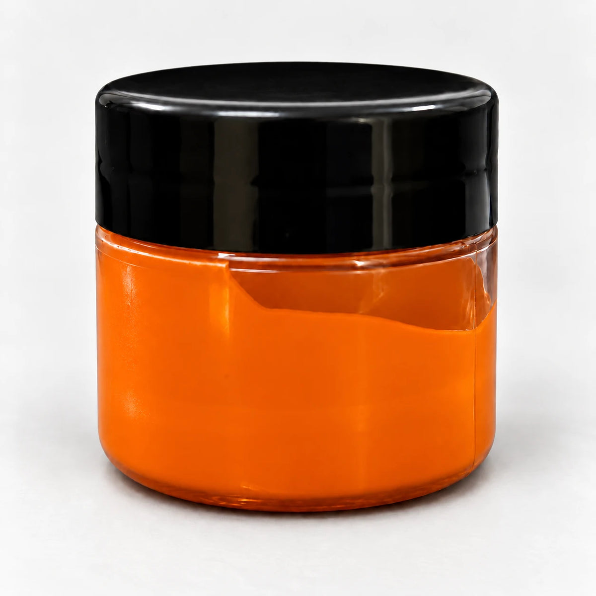 Orange Transparent Pigment in a clear jar with a black lid