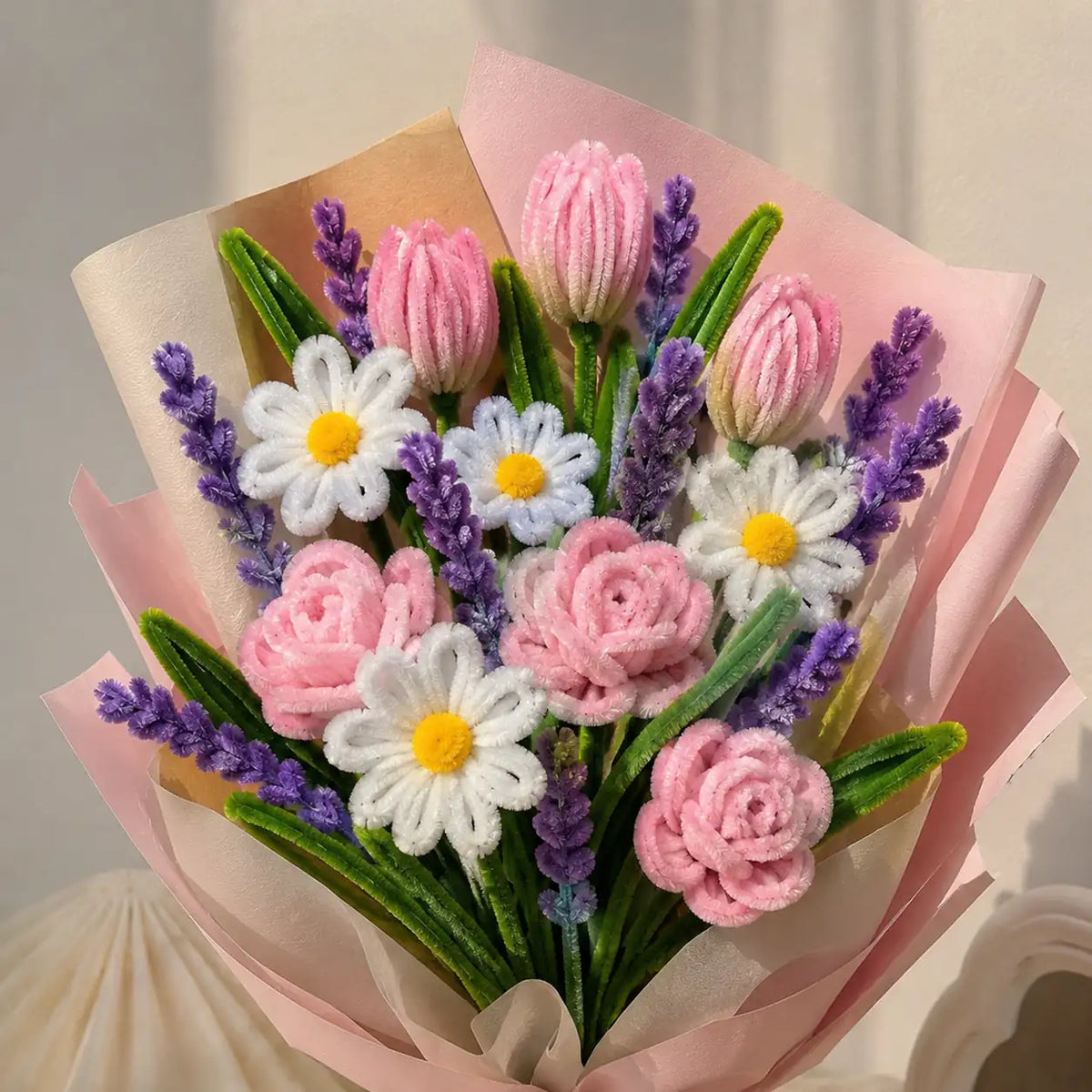 Close-up of handmade pink pipe cleaner roses and tulips with white daisies